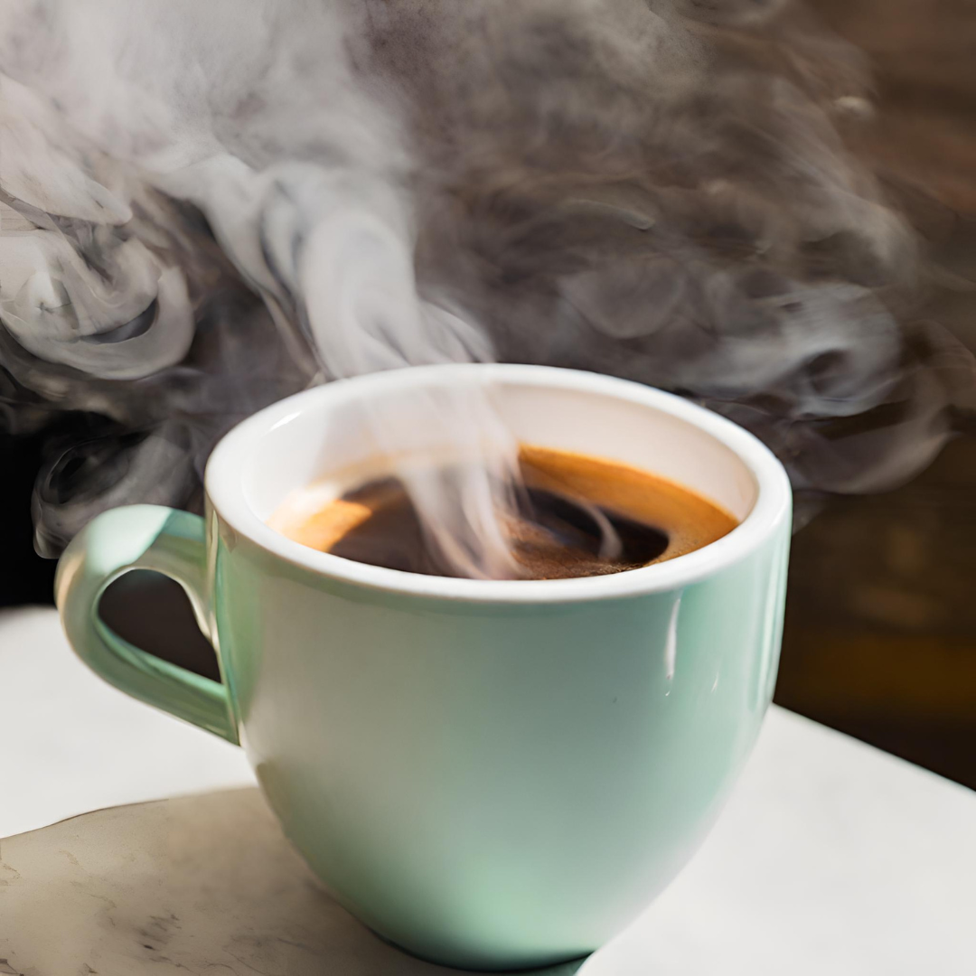 Steaming hot black coffee in a mint green ceramic mug on a white table, with swirling steam rising in soft light