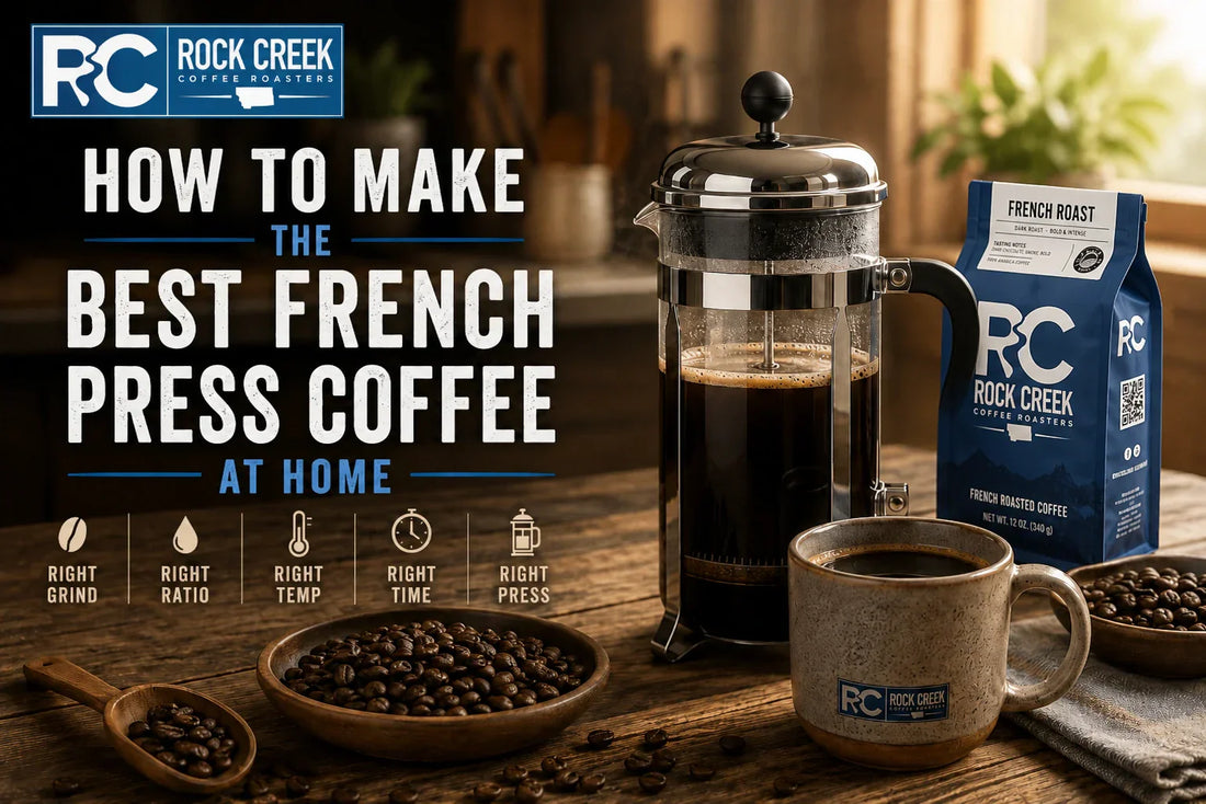 French press coffee brewing setup on a rustic kitchen counter featuring brewed coffee, a ceramic mug, whole coffee beans, and a Rock Creek Coffee Roasters coffee bag in warm natural light.
