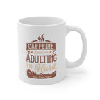 White Rock Creek Coffee mug featuring the phrase “Caffeine Because Adulting Is Hard” in brown and tan lettering with coffee bean graphics.