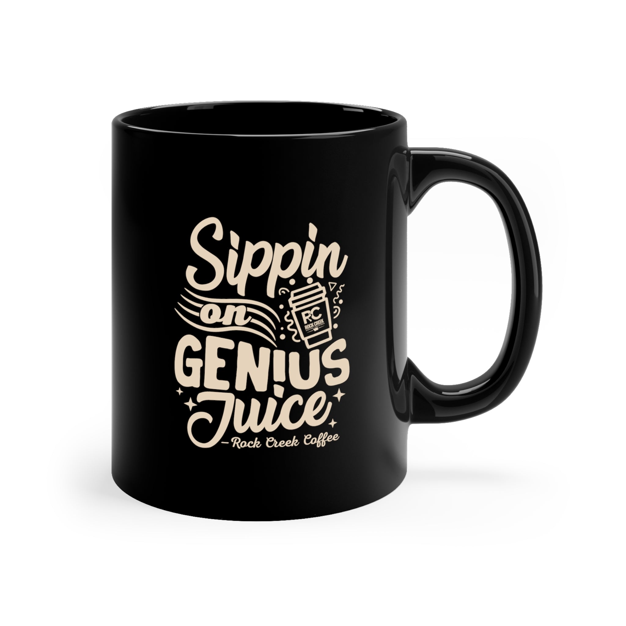Black ceramic coffee mug with “Sippin on Genius Juice Rock Creek Coffee” design in light lettering, filled with hot coffee and steam rising, displayed on a cozy tabletop with pinecones, a lit candle, cinnamon sticks, an orange, and soft string lights in the background.