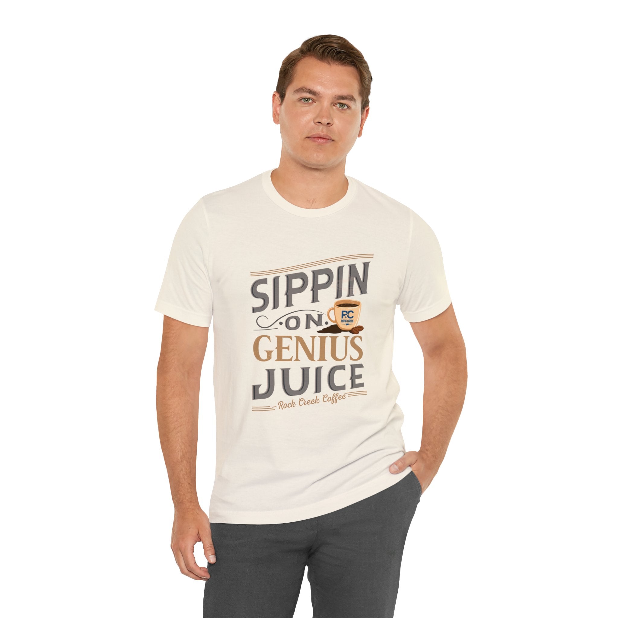 Adult man modeling a cream short-sleeve T-shirt with the “Sippin on Genius Juice” graphic printed across the chest in large coffee-inspired lettering, shown against a plain white background