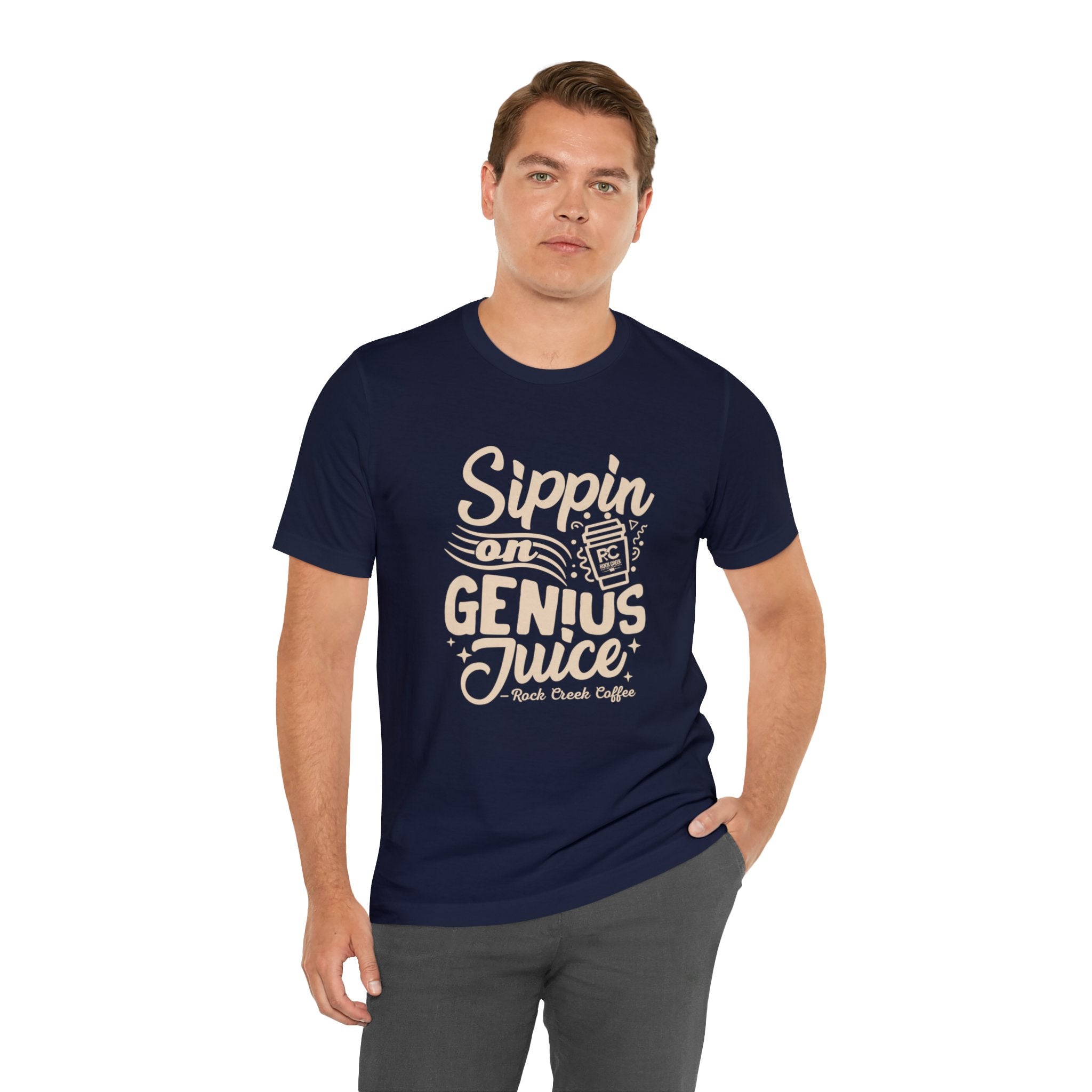 Adult man modeling a navy short-sleeve T-shirt printed with the slogan “Sippin on Genius Juice” and a stylized coffee to-go cup graphic on the front, shown against a plain white background.