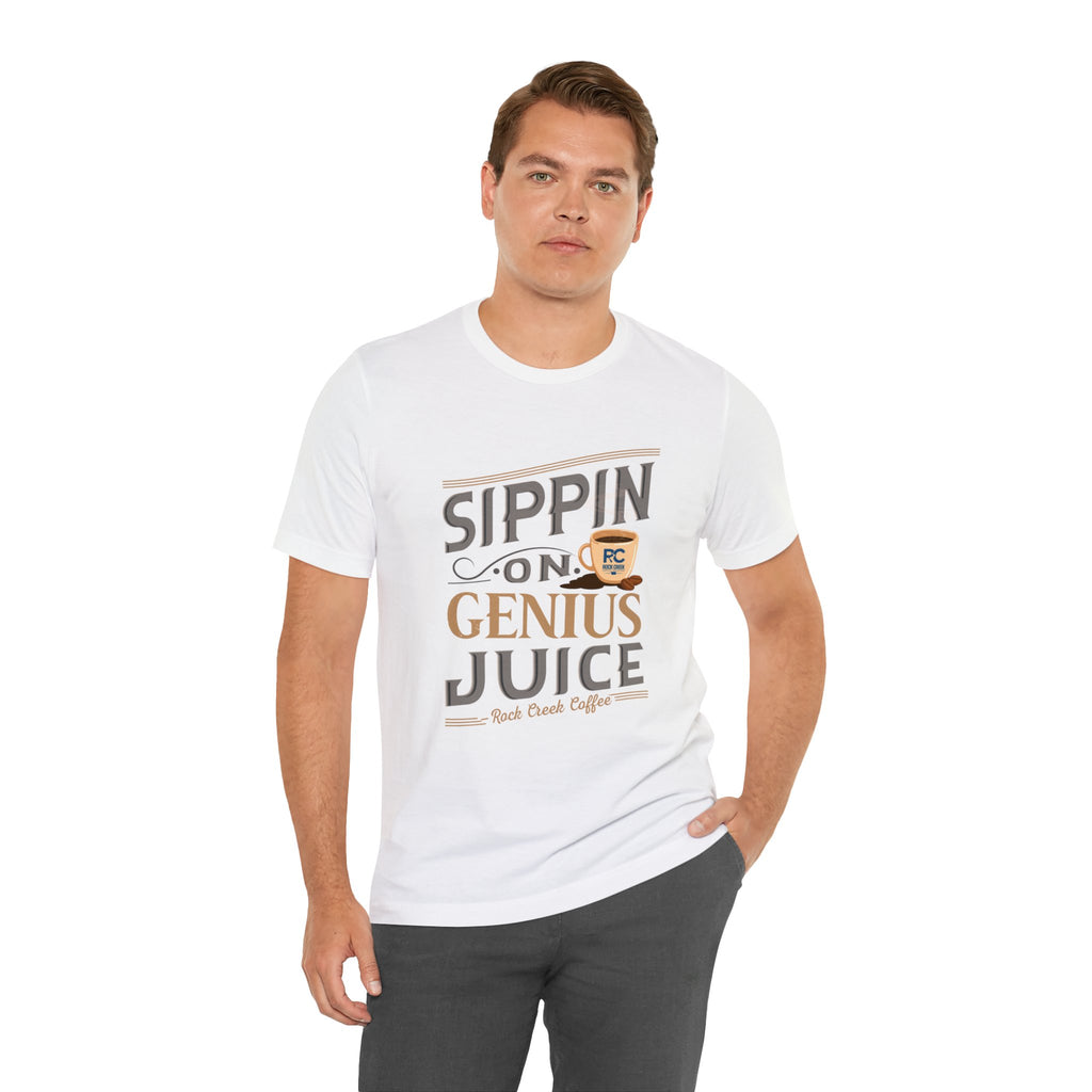Adult man modeling a white short-sleeve T-shirt printed with the “Sippin on Genius Juice” graphic in bold coffee-inspired lettering with a small mug illustration, posed against a plain white background.