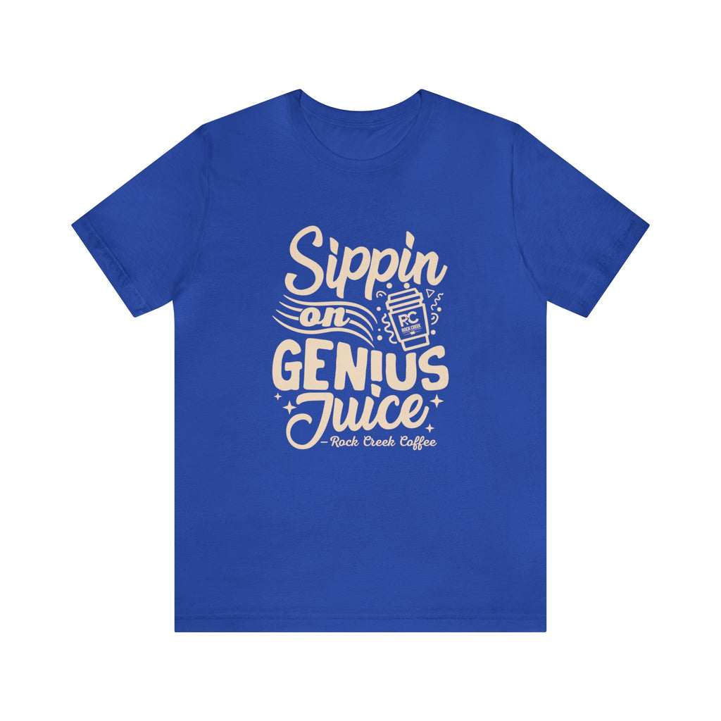 Royal blue short-sleeve T-shirt displayed flat on a white background featuring a bold coffee-themed graphic that reads “Sippin on Genius Juice” with a stylized coffee cup illustration.