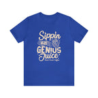 Royal blue short-sleeve T-shirt displayed flat on a white background featuring a bold coffee-themed graphic that reads “Sippin on Genius Juice” with a stylized coffee cup illustration.