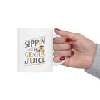 White Rock Creek Coffee mug featuring the phrase “Sippin on Genius Juice” in stylized gray and gold lettering with a small RC coffee cup graphic, shown held by a hand with red painted nails against a plain white background.