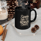 Black ceramic Rock Creek Coffee mug with “Sippin on Genius Juice” design in cream lettering, filled with steaming coffee and styled with pinecones, a lit candle, cinnamon sticks, an orange, and warm string lights in a cozy setting.