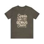 Olive green short-sleeve T-shirt displayed flat against a white background featuring a bold coffee-themed graphic that reads “Sippin on Genius Juice” with a stylized coffee to-go cup illustration.