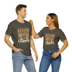 Adult man and woman modeling matching army green short-sleeve T-shirts featuring the “Around the Corner from Ordinary” graphic in a bold coffee-themed typographic design, posed together against a plain white background.