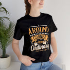 Woman wearing a black Rock Creek Coffee T-shirt with the “Around the Corner From Ordinary” graphic in a casual indoor lifestyle photo