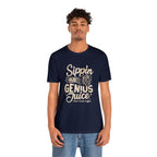 Adult man modeling a navy short-sleeve T-shirt printed with the slogan “Sippin on Genius Juice” and a stylized coffee to-go cup graphic on the front, shown against a plain white background.