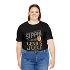 Adult woman smiling while modeling a black short-sleeve T-shirt featuring the “Sippin on Genius Juice” graphic in bold coffee-inspired lettering with a small cup illustration, shown against a plain white background.