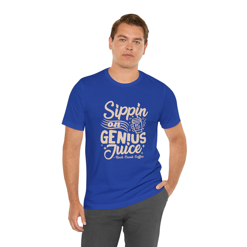 Adult man modeling a royal blue short-sleeve T-shirt printed with the slogan “Sippin on Genius Juice” and a stylized coffee to-go cup graphic on the front, displayed against a white background.