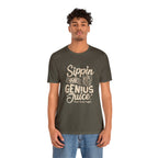 Adult man modeling an olive green short-sleeve T-shirt printed with the slogan “Sippin on Genius Juice” and a stylized coffee to-go cup graphic on the front, shown against a plain white background.