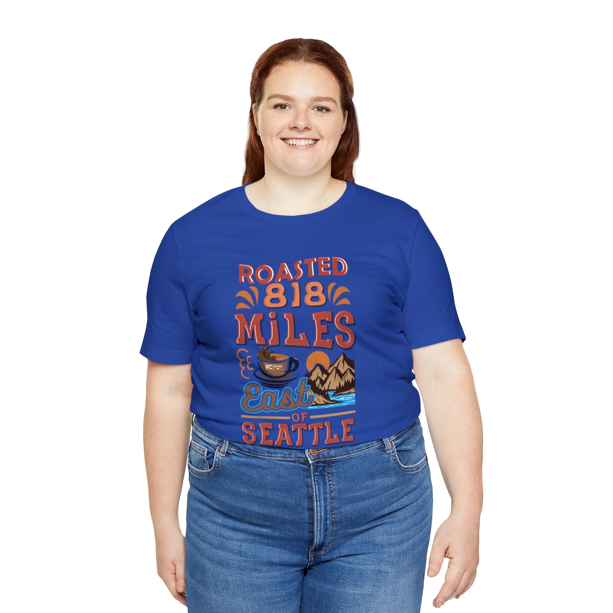 Women’s royal blue Seattle coffee graphic T-shirt with “Roasted 818 Miles East of Seattle” artwork, modeled on a plain white background.