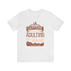 Ash short-sleeve T-shirt displayed flat against a plain white background, featuring the “Caffeine Because Adulting Is Hard” graphic in a stacked typographic design with Rock Creek Coffee branding below.