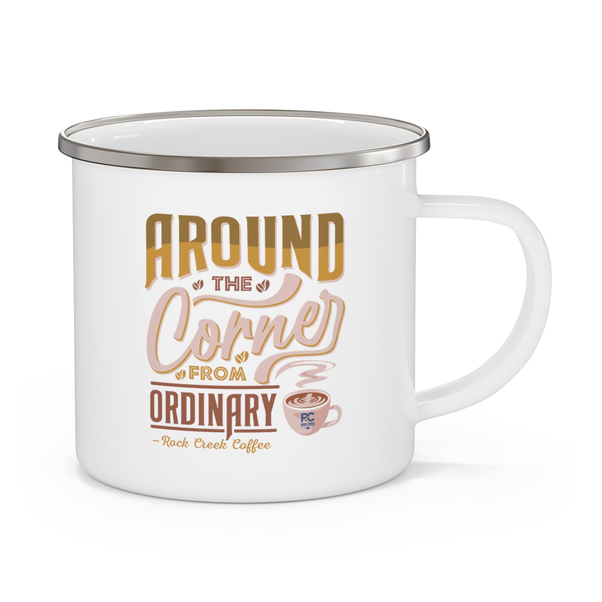 White enamel style coffee mug with silver rim and handle featuring the phrase Around the Corner from Ordinary Rock Creek Coffee in tan and brown lettering with a small coffee cup illustration.