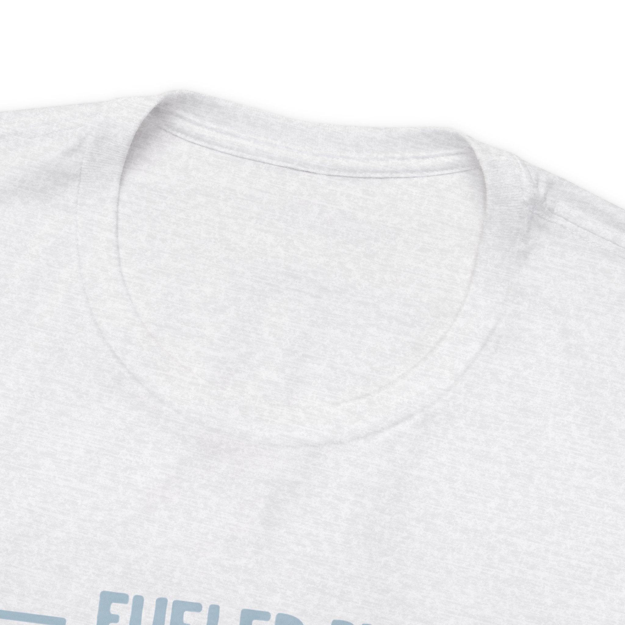 Close-up detail of an ash crew neck T-shirt showing the neckline and upper chest area, with the top edge of the “Fueled by Coffee and Dad Jokes” graphic partially visible against a plain white background.