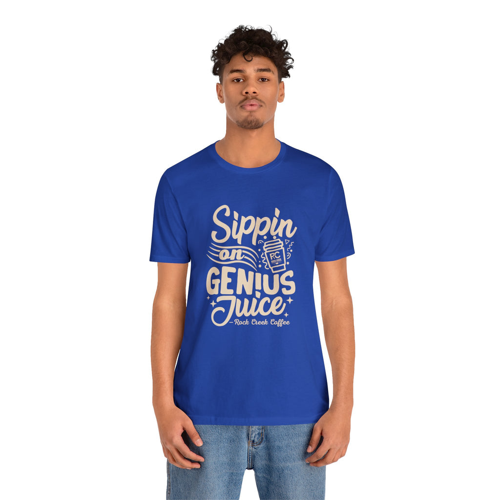 Adult man modeling a royal blue short-sleeve T-shirt printed with a coffee slogan that says “Sippin on Genius Juice” and includes a stylized coffee to-go cup graphic, shown against a white background.