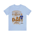 Light blue short-sleeve T-shirt laid flat on white background showing a coffee-themed graphic that reads “Fueled by Coffee and Dad Jokes” alongside a stylized coffee cup and bearded cartoon dad holding a mug.
