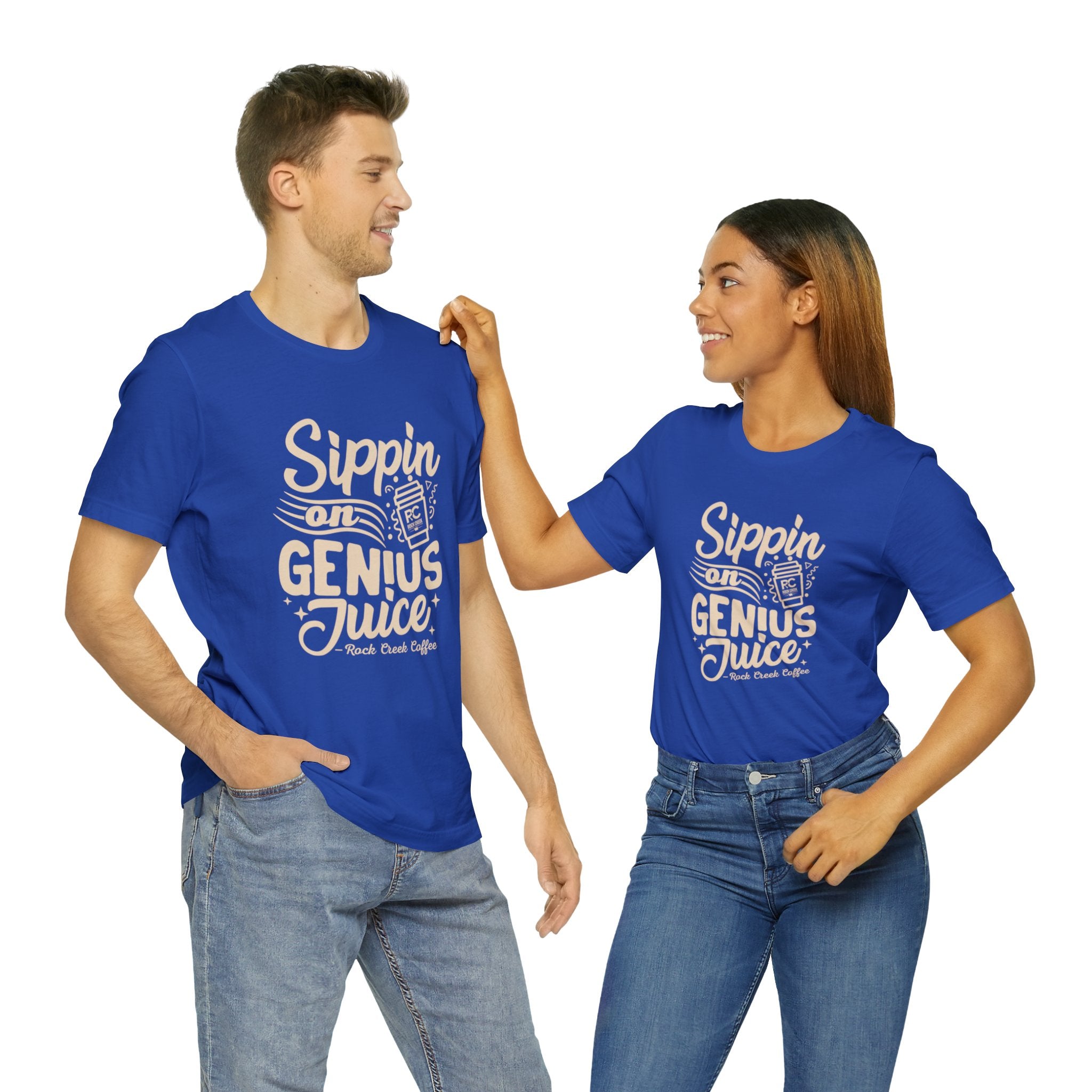 Smiling man and woman standing side by side, both wearing royal blue short-sleeve T-shirts printed with the slogan “Sippin on Genius Juice” and stylized coffee to-go cup graphics on the front, shown against a white background.