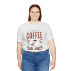 Adult woman smiling while modeling an ash short-sleeve T-shirt featuring the “Fueled by Coffee and Dad Jokes” graphic with a coffee cup illustration and Rock Creek Coffee text, shown against a plain white background.