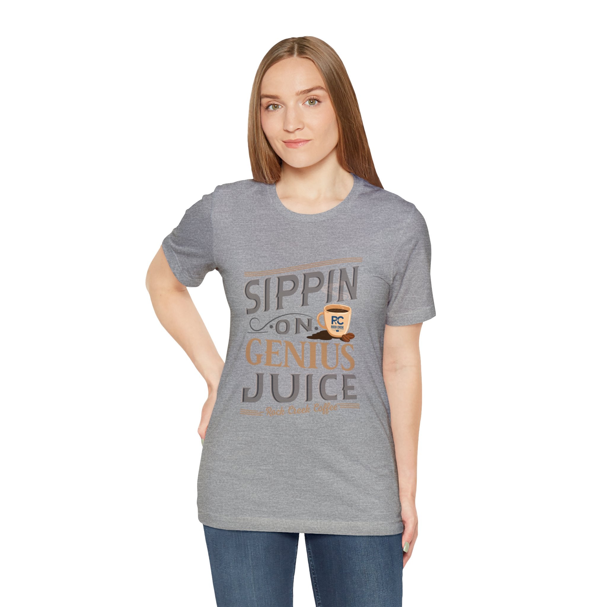 Adult woman modeling a heather gray short-sleeve T-shirt with the “Sippin on Genius Juice” graphic printed across the chest in bold coffee-inspired lettering, shown against a plain white background.
