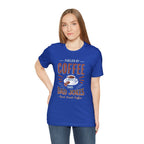 Adult woman modeling a royal blue short-sleeve T-shirt featuring the “Fueled by Coffee and Dad Jokes” graphic with a coffee cup illustration and Rock Creek Coffee text, shown against a plain white background.
