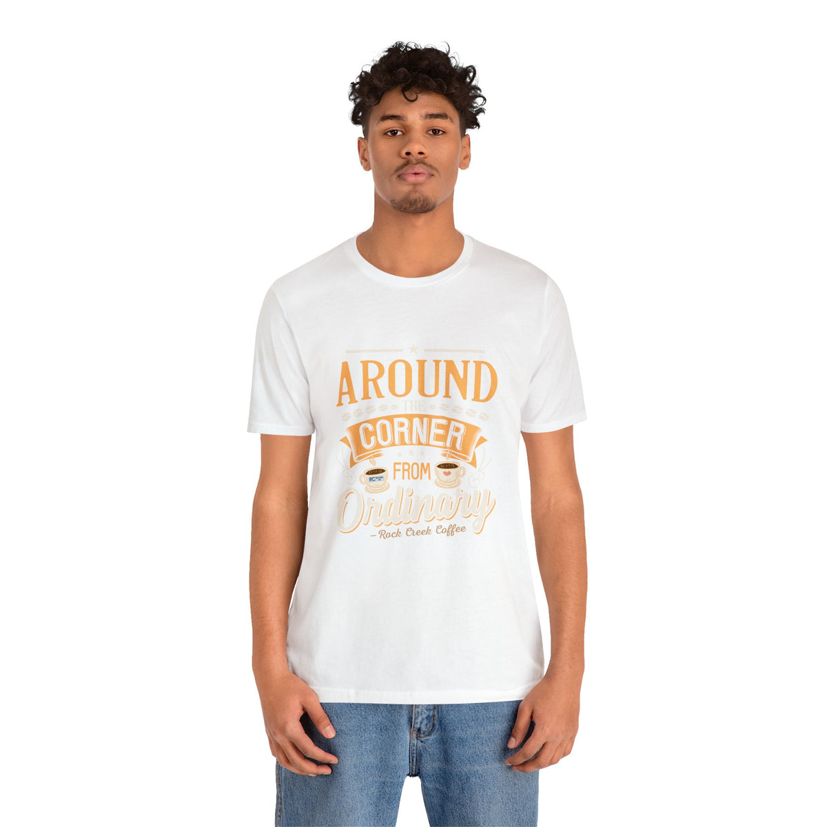 Male model wearing a white Rock Creek Coffee T-shirt featuring the “Around the Corner From Ordinary” graphic print