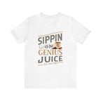 White short-sleeve T-shirt displayed flat against a plain white background, featuring the “Sippin on Genius Juice” graphic in bold coffee-inspired lettering with a small mug illustration.