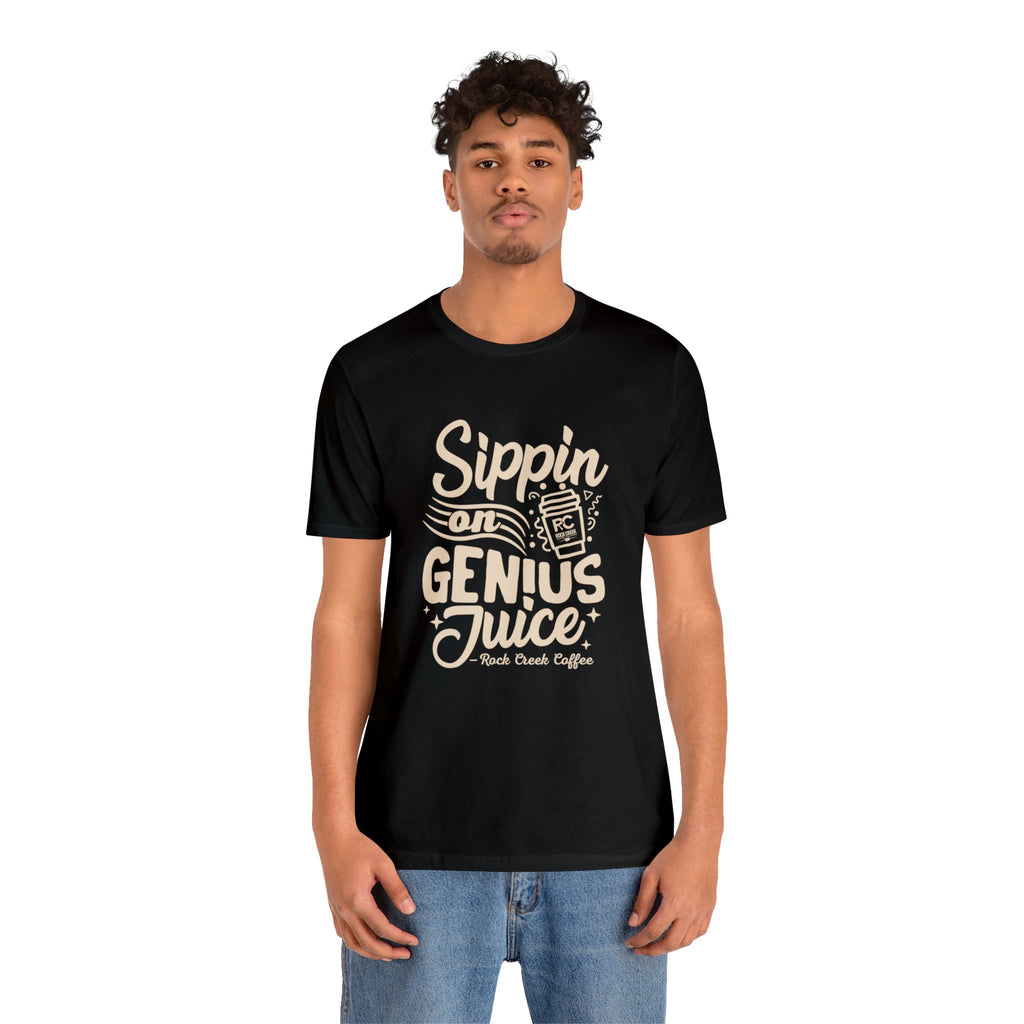 Adult man modeling a black short-sleeve T-shirt printed with the slogan “Sippin on Genius Juice” and a stylized coffee to-go cup graphic on the front, shown against a plain white background.