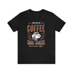 Black short-sleeve T-shirt displayed flat against a plain white background, featuring a bold graphic that reads “Fueled by Coffee and Dad Jokes” with a coffee cup illustration and Rock Creek Coffee text below.