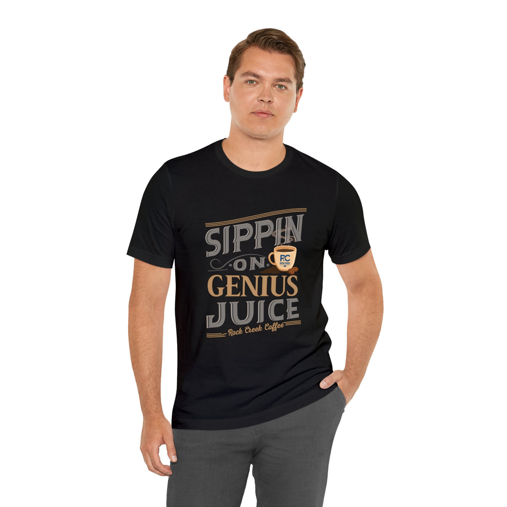 Adult man modeling a black short-sleeve T-shirt with the “Sippin on Genius Juice” graphic printed across the chest in bold coffee-inspired lettering, shown against a plain white background.