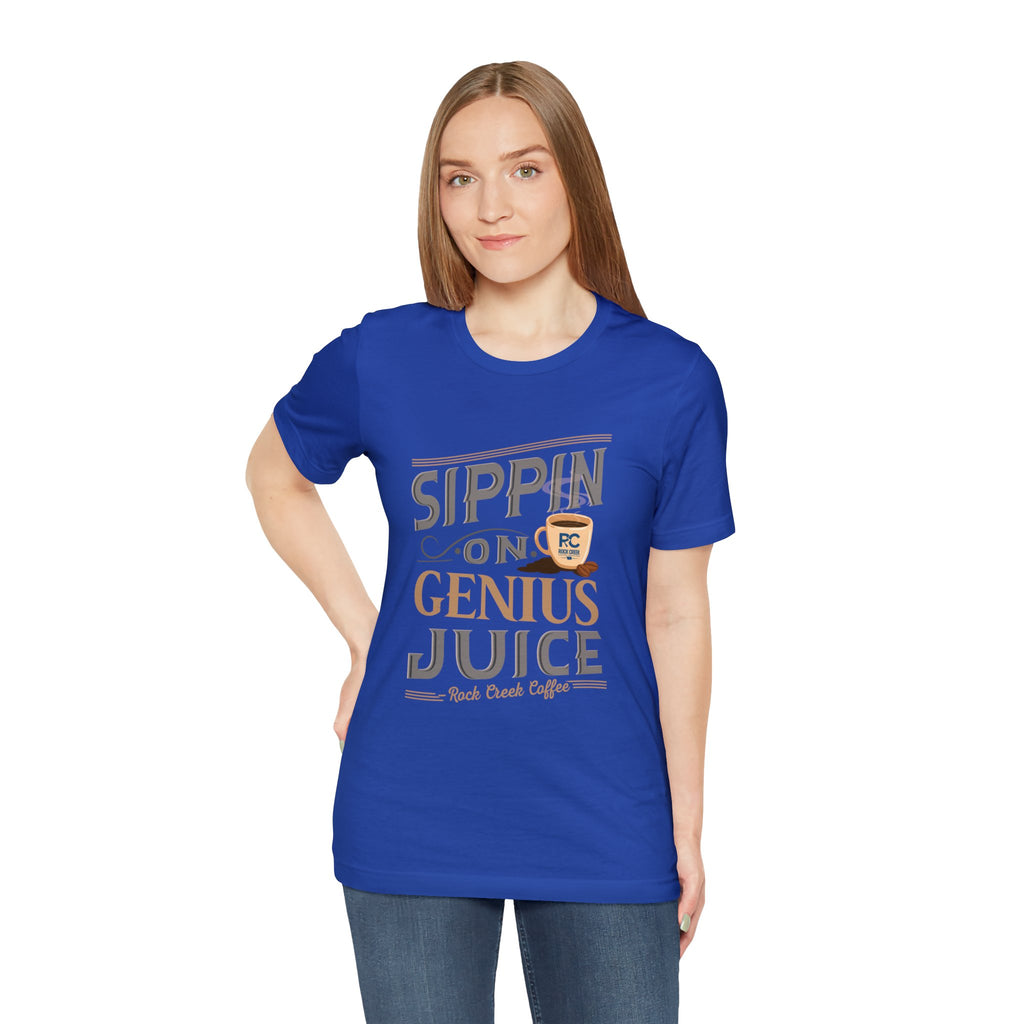 Adult woman posing in a black short-sleeve T-shirt featuring the “Sippin on Genius Juice” graphic in bold coffee-inspired lettering with a small mug illustration, shown against a plain white background.