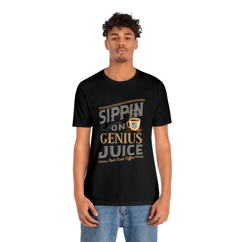 Adult man modeling a black short-sleeve T-shirt featuring the “Sippin on Genius Juice” graphic in bold coffee-inspired lettering with a small coffee cup illustration, shown against a plain white background.