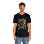 Adult man modeling a black short-sleeve T-shirt featuring the “Sippin on Genius Juice” graphic in bold coffee-inspired lettering with a small coffee cup illustration, shown against a plain white background.