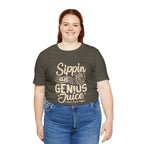 Smiling woman modeling an olive green short-sleeve T-shirt printed with the slogan “Sippin on Genius Juice” and a stylized coffee to-go cup graphic on the front, shown against a plain white background.