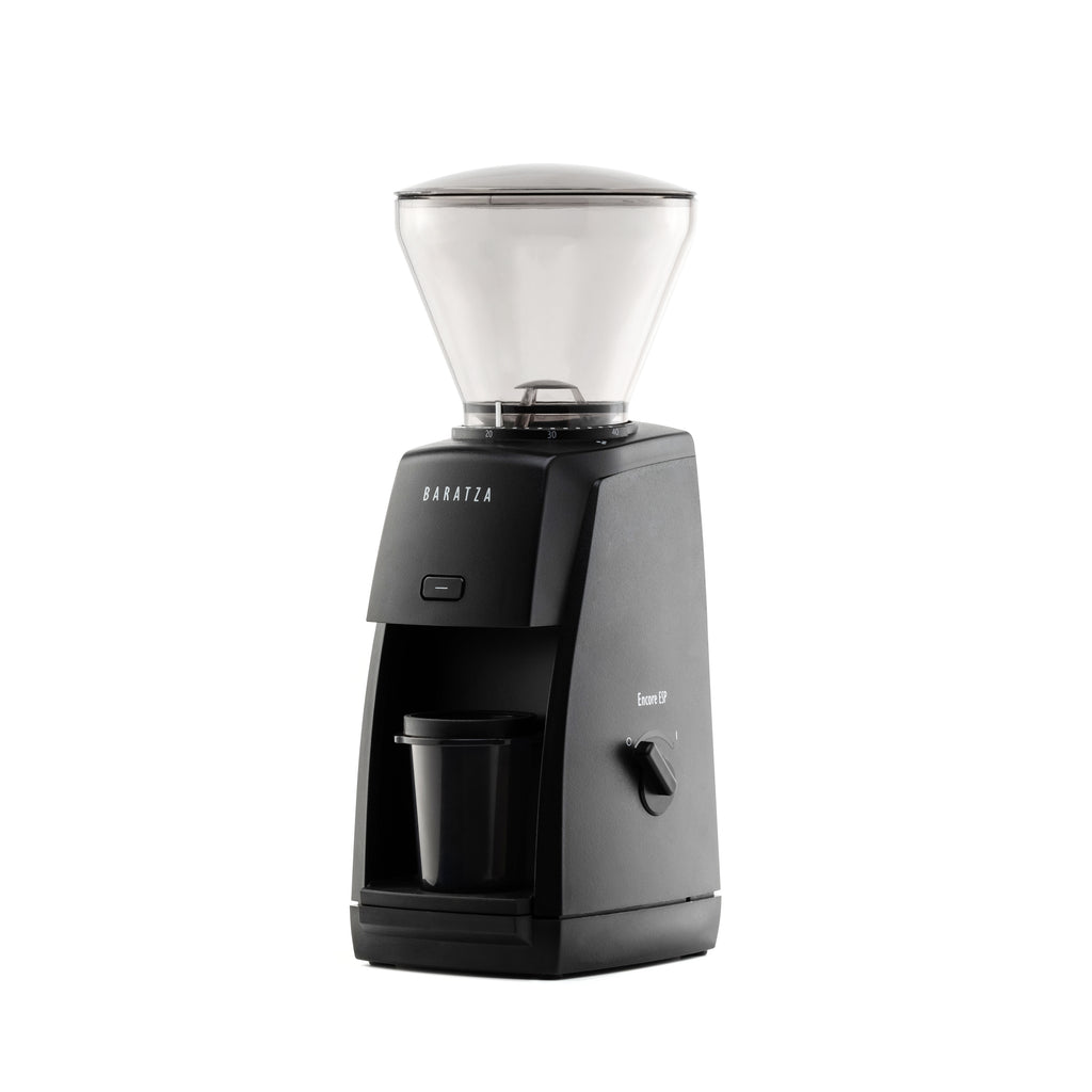 Three-quarter left view of the black Baratza Encore ESP coffee grinder with a clear bean hopper and included dosing cup, displayed against a white background.