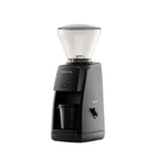 Three-quarter left view of the black Baratza Encore ESP coffee grinder with a clear bean hopper and included dosing cup, displayed against a white background.