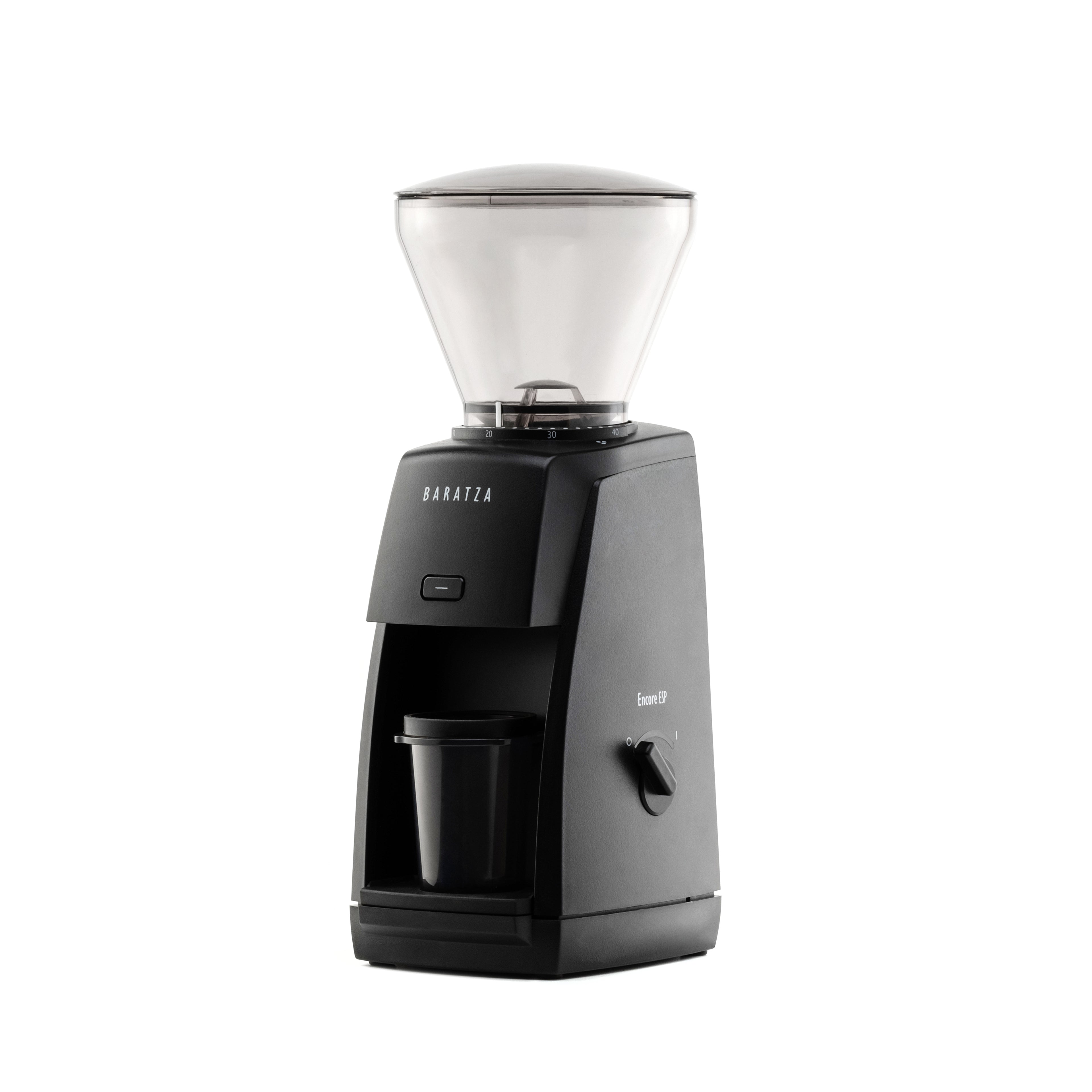 Three-quarter left view of the black Baratza Encore ESP coffee grinder with a clear bean hopper and included dosing cup, displayed against a white background.