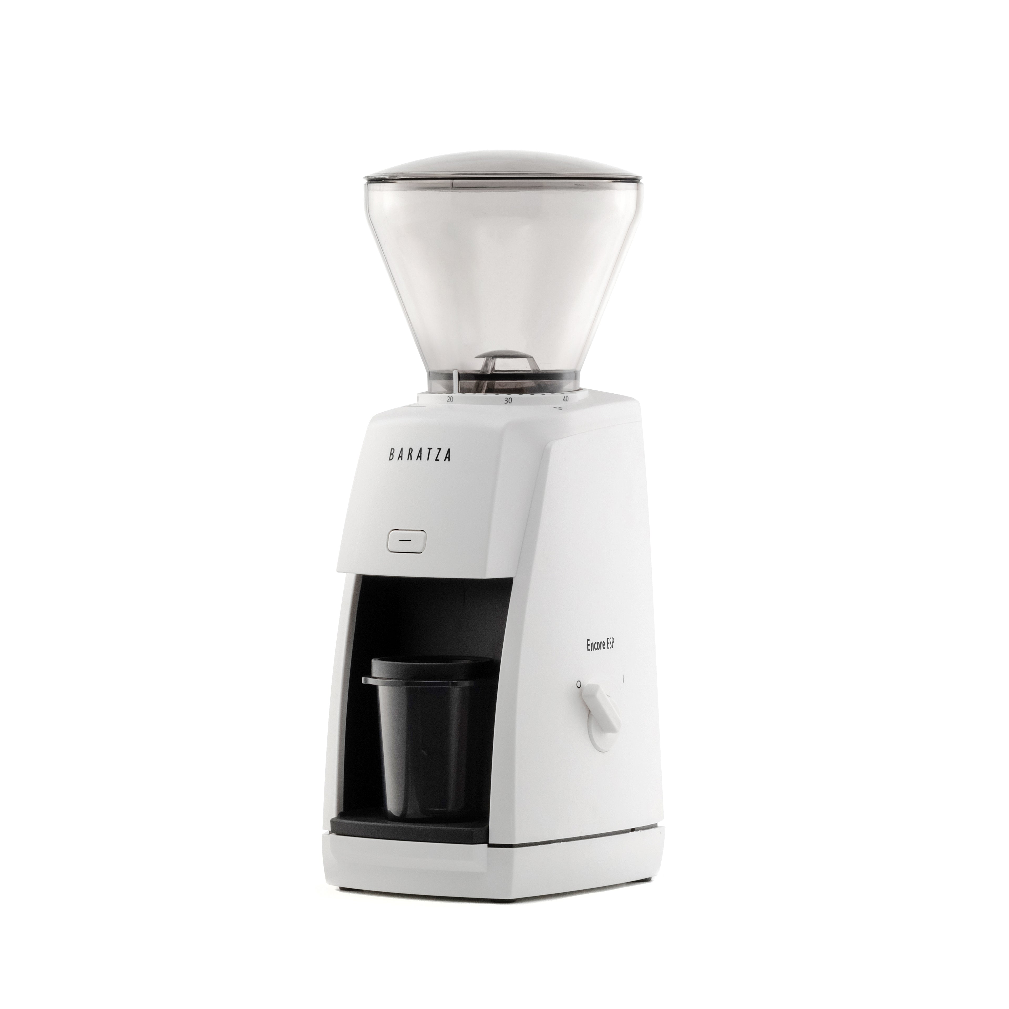 Three-quarter left view of the white Baratza Encore ESP coffee grinder with clear bean hopper and included dosing cup, displayed against a white background.