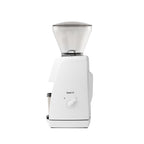 Side view of the white Baratza Encore ESP coffee grinder with clear bean hopper and included dosing cup, displayed against a white background.