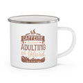 White enamel-style coffee mug with silver rim featuring the phrase “Caffeine Because Adulting Is Hard – Rock Creek Coffee” in brown and tan lettering, displayed against a white background.