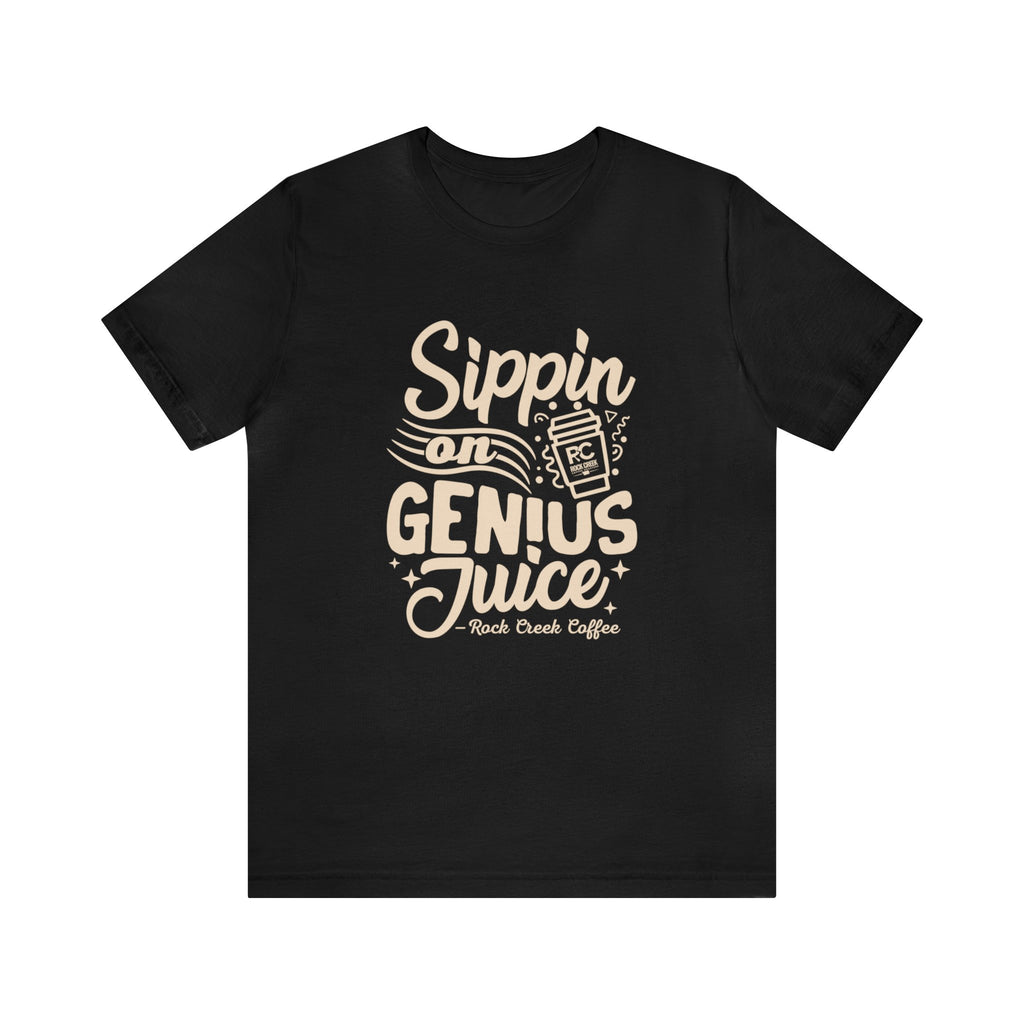 Black short-sleeve T-shirt displayed flat against a white background featuring a bold coffee-themed graphic that reads “Sippin on Genius Juice” with a stylized coffee to-go cup illustration.
