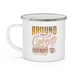 White enamel style coffee mug with silver rim and handle featuring the phrase Around the Corner from Ordinary Rock Creek Coffee in tan, gold, and brown lettering with a small latte cup illustration.
