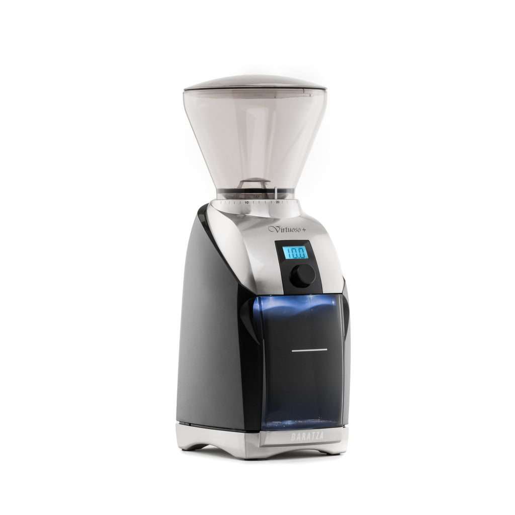 Three quarter left view of a Baratza Virtuoso Plus coffee grinder in black and stainless steel, featuring a clear bean hopper, digital timer display, front control knob, and blue-tinted grounds bin on a white background.