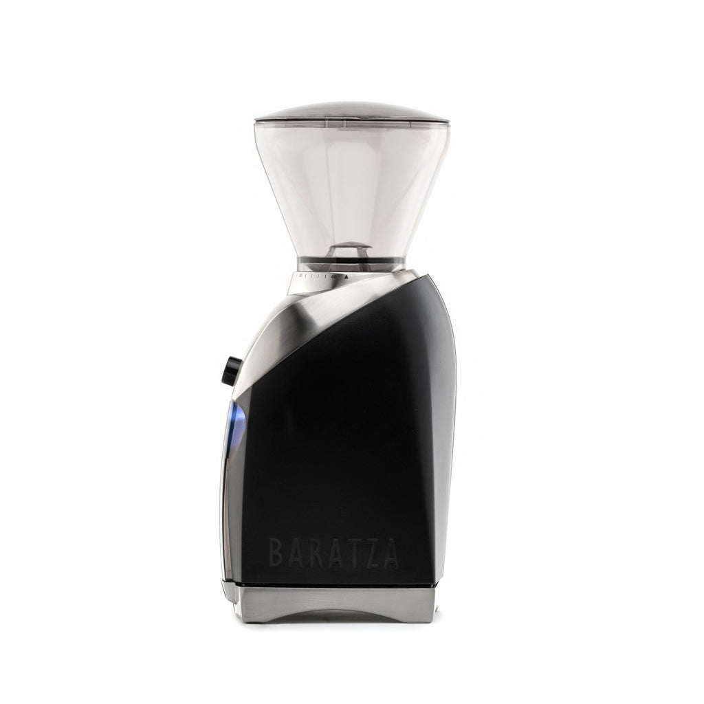 Side view of a Baratza Virtuoso Plus coffee grinder in black with stainless steel accents and clear bean hopper, displayed against a white background.