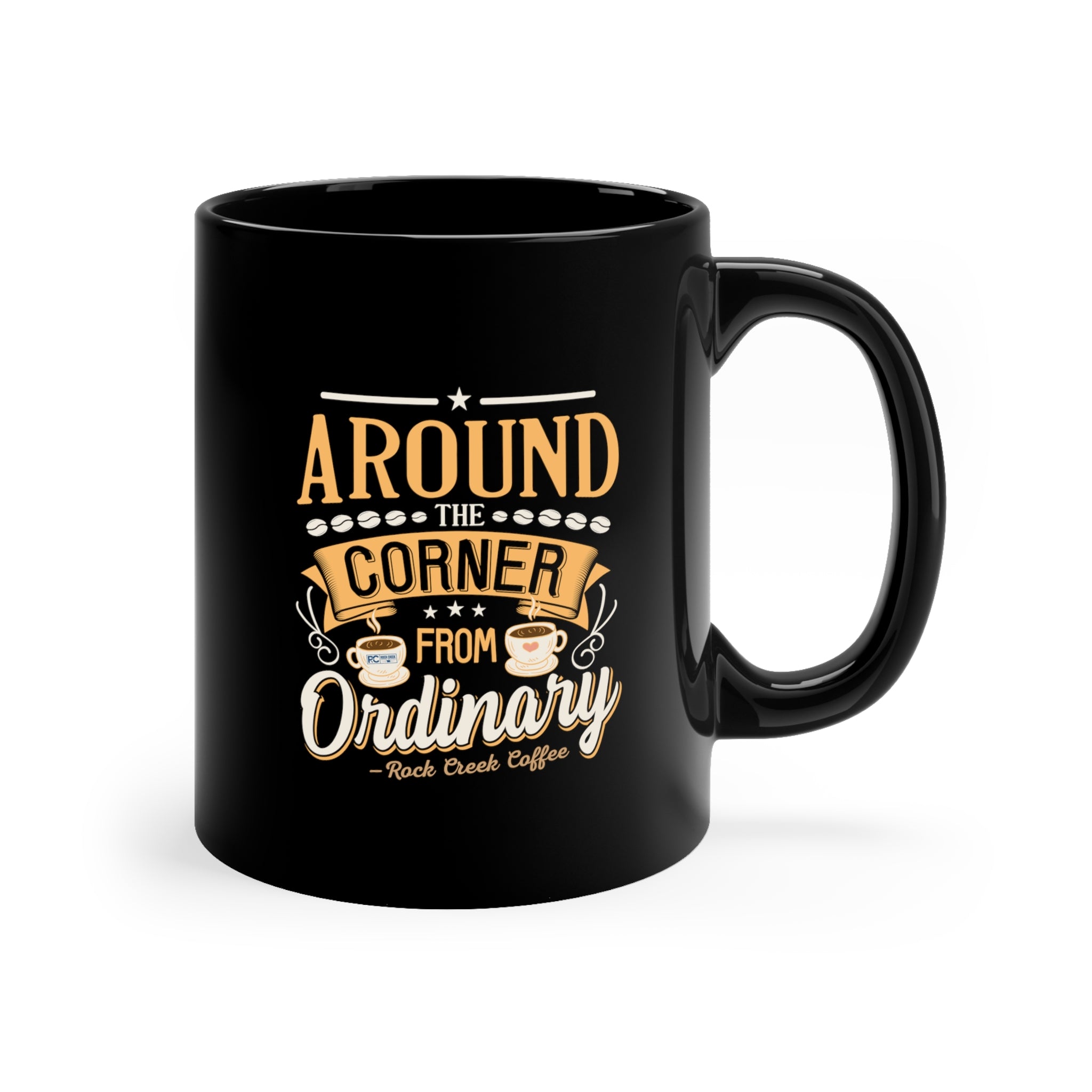 Black ceramic coffee mug with a glossy finish featuring the phrase “Around the Corner from Ordinary – Rock Creek Coffee” in gold and white lettering, accented with small coffee cup illustrations and decorative stars.