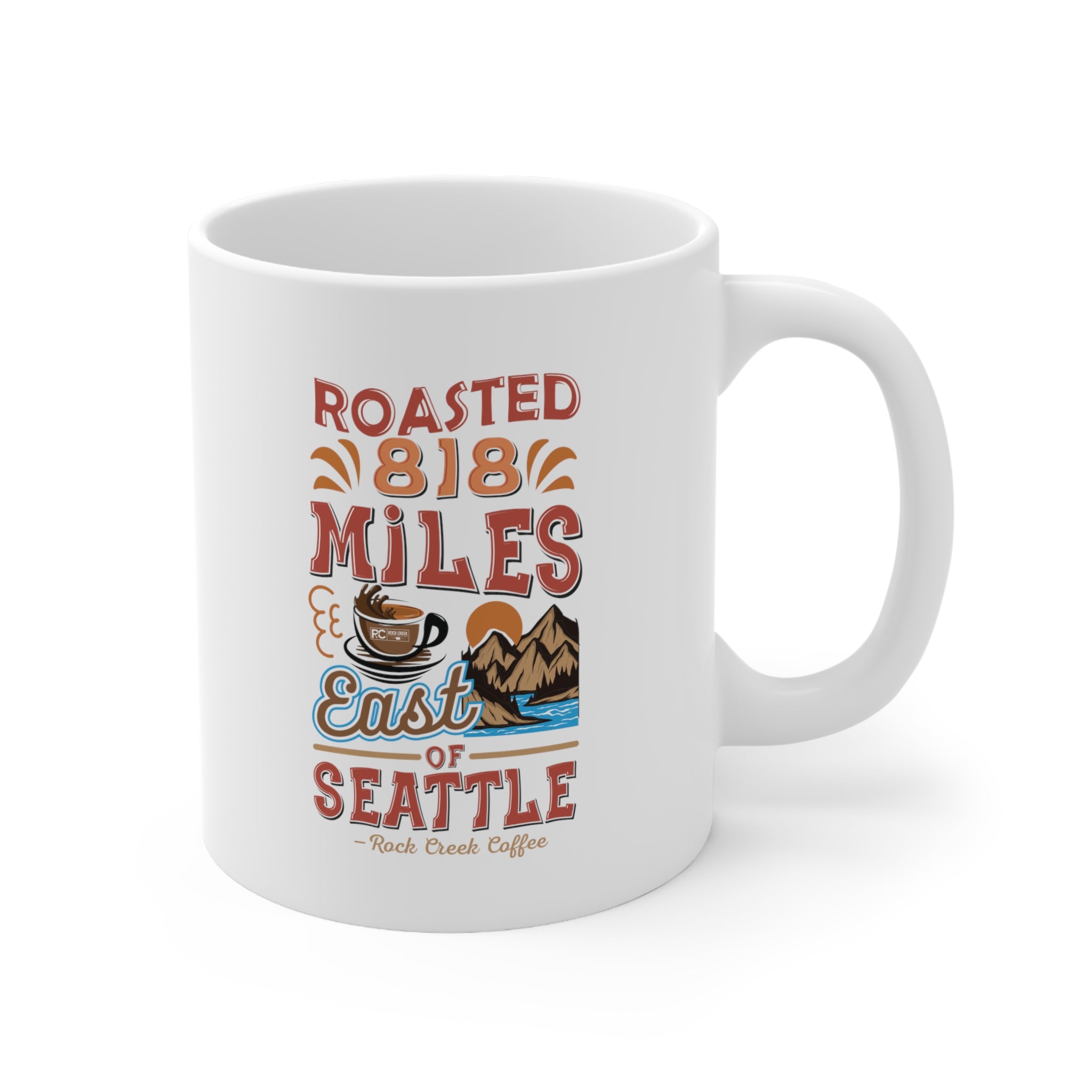 White Rock Creek Coffee mug featuring a colorful “Roasted 818 Miles East of Seattle” design with a coffee cup illustration, mountains, water, and retro style lettering on a white background.