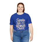 Smiling woman modeling a royal blue short-sleeve T-shirt printed with the slogan “Sippin on Genius Juice” and a stylized coffee to-go cup graphic on the front, shown against a white backdrop.